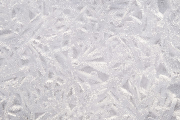 winter background.frozen ice crystals on the surface of the water