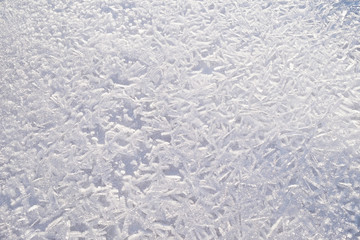 winter background.frozen ice crystals on the surface of the water