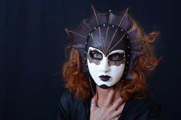 girl with red hair in an old Venetian mask
