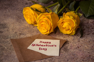 Yellow roses and envelope with text Happy St. Valentine's Day