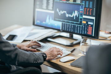 Businesspeople working with finance forecasts on their computers