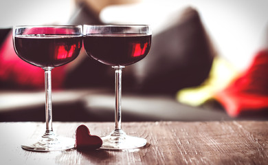 two glasses of red wine on a  table
