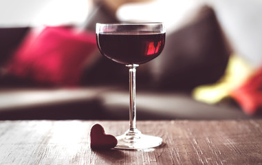 one glasses of red wine on a  table