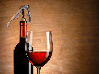 Wine glass and bottle on a wooden background