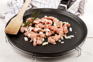 chicken stir fry with onion on a pan