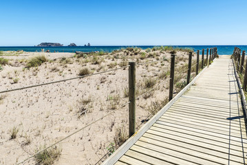 Wooden path to the beach in Costa Brava, Spain