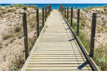 Wooden path to the beach in Costa Brava, Spain