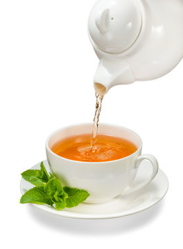 Tea being poured into glass tea cup