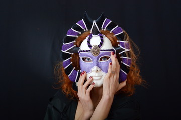 girl with red hair in an old Venetian mask