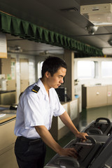 Fototapeta na wymiar Young Chinese Navigator Navigating his Ship