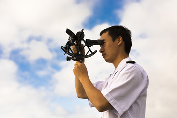 Young Chinese Navigator Doing Celestial Observation with Sextant