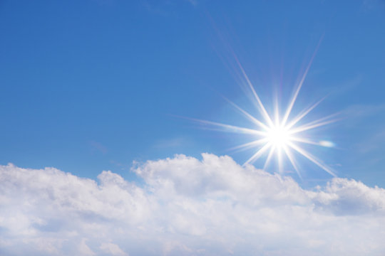Shining sun at clear blue sky with free text space