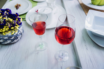 Red wine in a glass. Light background