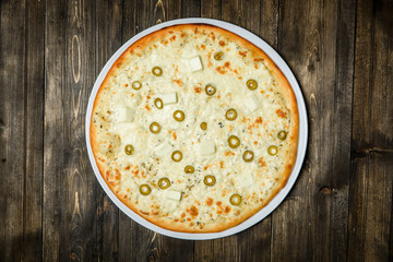 Top view of Italian rustic PIZZA on wooden table background