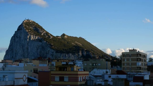 Evening timelapse of Gibraltar Rock and La Linea de la Concepcion cityscape during sunset in Spain.
