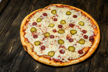 Top view of Italian rustic PIZZA on wooden table background