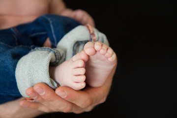 baby feet in father's hands