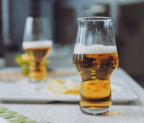 Beer and chips on the large white table