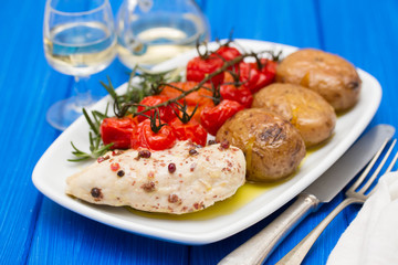 chicken with potato and tomato on dish