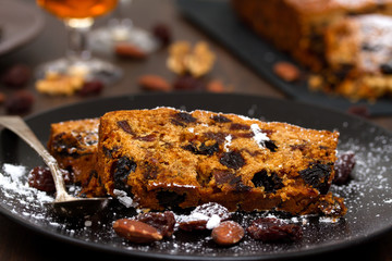 cake with dry fruits on brown plate