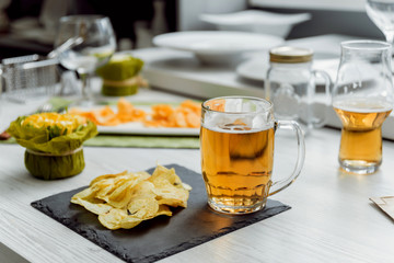 Beer and chips on the large white table