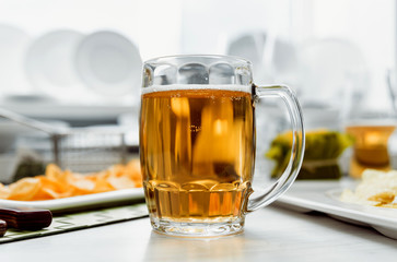 Beer and chips on the large white table