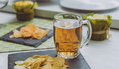 Beer and chips on the large white table