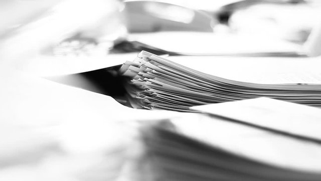 Close up of paper stacks, unsolved paper documents in the office. Shallow DOF. Suitable for backgrounds.