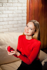 Young beautiful girl holding her engagement ring in excitement