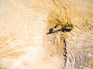 erial view of a working excavator in the mine. Industrial background on mining theme. 