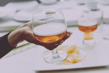 Glass of lager beer in the hands