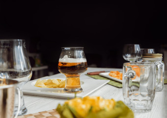 Beer and chips on the large white table