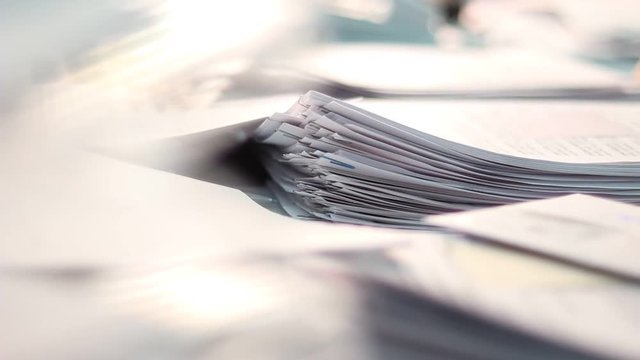 Close up of paper stacks, unsolved paper documents in the office. Shallow DOF. Suitable for backgrounds.