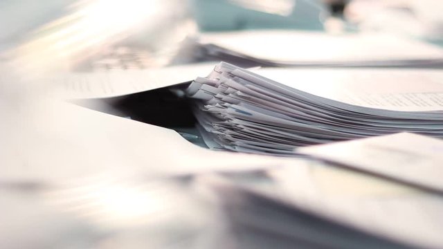 Close up of paper stacks, unsolved paper documents in the office. Shallow DOF. Suitable for backgrounds.