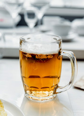 Beer and chips on the large white table