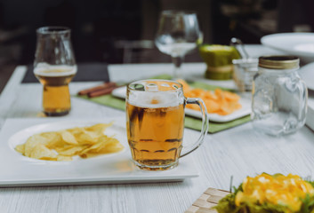 Beer and chips on the large white table