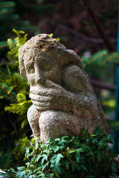 statue in the garden with a closed mouth