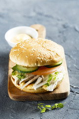 Chicken burger with cucumber and tomatoes