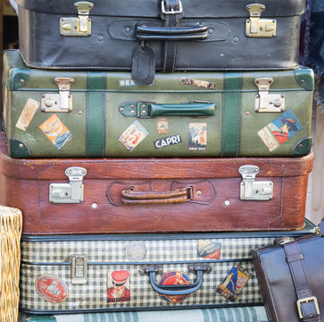  Pile of colorful vintage suitcases.