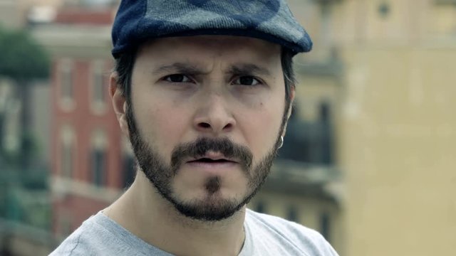 close up on angry man attacks verbally the camera