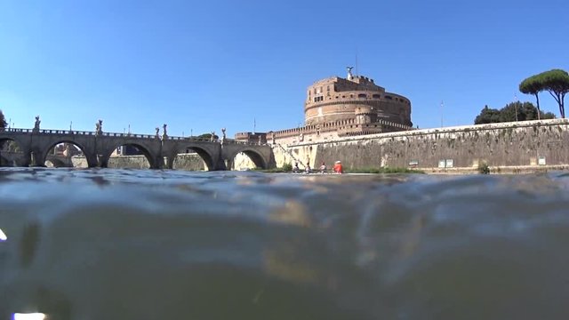 Castel Sant angelo fortress and bridge in Rome, Italy. View from the river,rowers on canoe