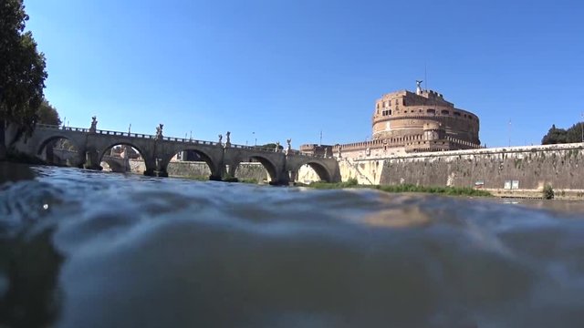 Castel Sant angelo fortress and bridge in Rome, Italy. View from the river, across the water.