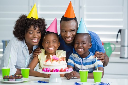 Happy Family Celebrating Birthday Party At Home