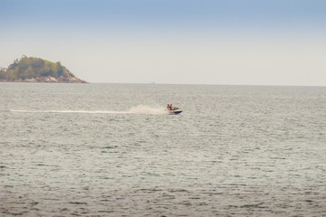 Tourist enjoy jet ski riding around the Beautiful seascape view of Kalim beach, the small beach of Kalim fishermen village, Kalim Beach is nearby Patong beach.