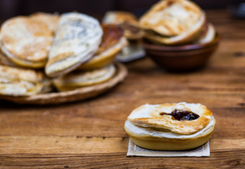 Meat and vegetable pies on the wooden table