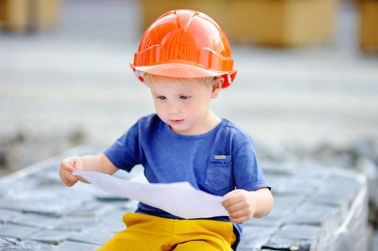 Little builder reading construction drawing