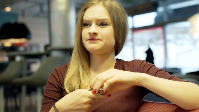 Unhappy girl checks her new watch and look dissatisfied
