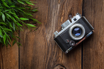 Vintage camera on wooden background.