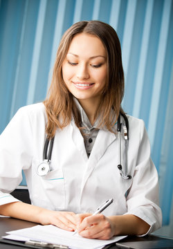 smiling young female doctor at office