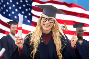 happy student with diploma celebrating graduation